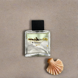 Perfume bottle labeled 'kaysu' with a shell on a beige background
