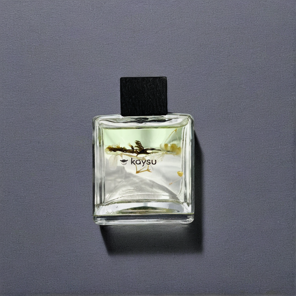 Clear glass bottle with black cap on a gray background