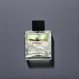 Clear glass bottle with black cap on a gray background