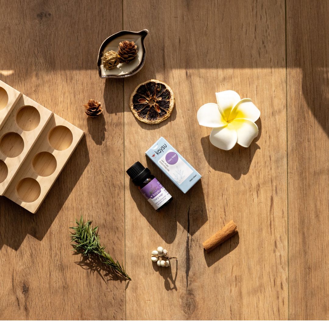 Wooden mold, essential oils, and flowers on a wooden surface