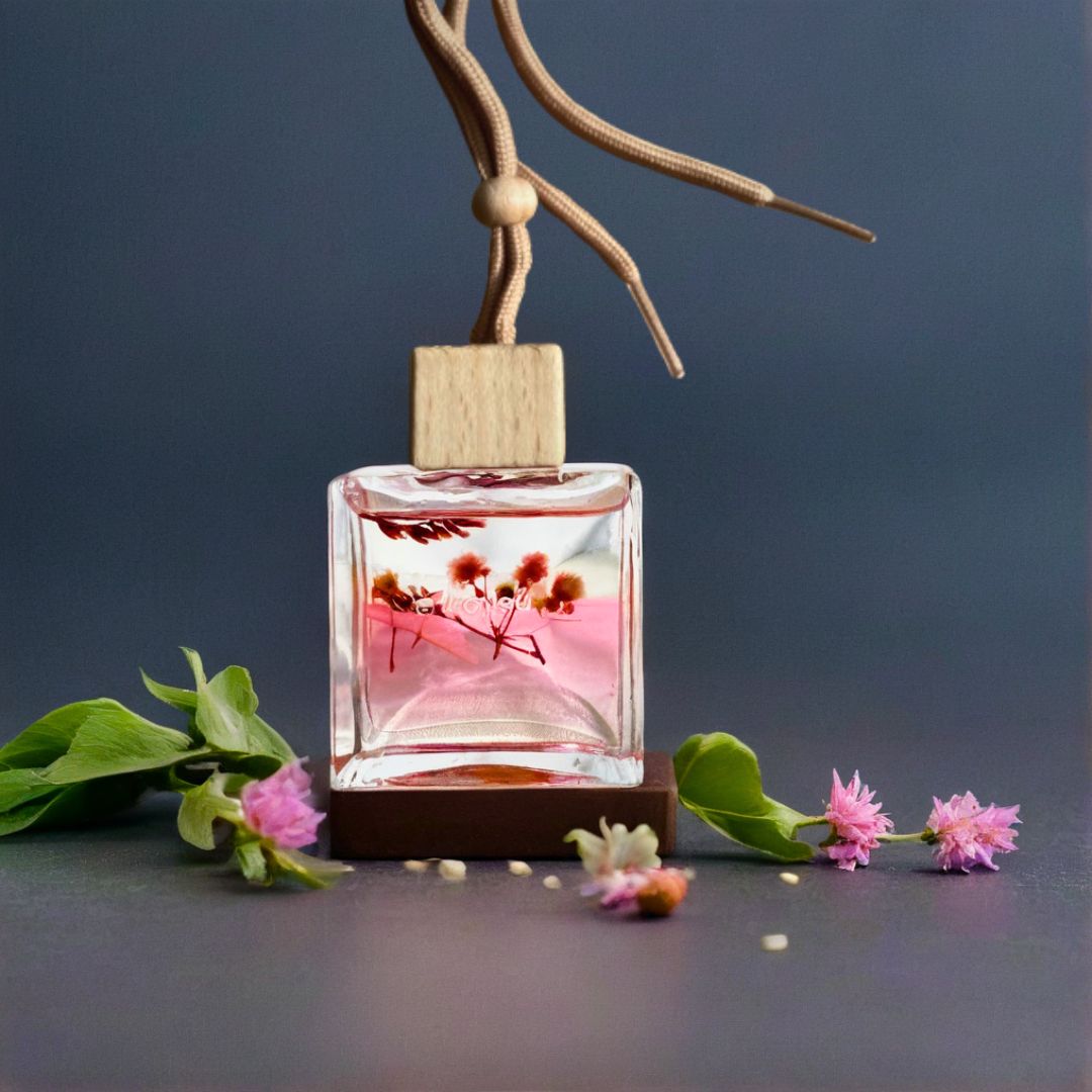 Car air freshener with floral design on a dark background