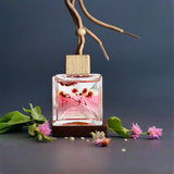 Car air freshener with floral design on a dark background