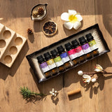 Set of small bottles with colorful labels on a wooden surface with decorative elements.